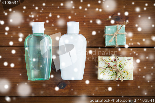Image of handmade soap bars and lotion bottles on wood