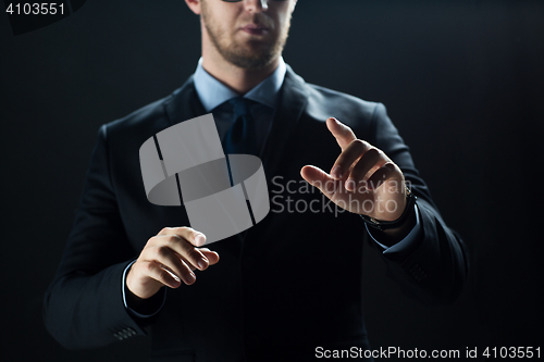 Image of close up of businessman touching virtual screen