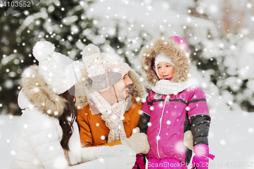 Image of happy family with child in winter clothes outdoors