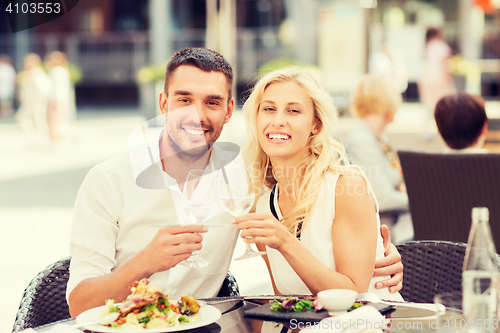 Image of happy couple clinking glasses at restaurant lounge