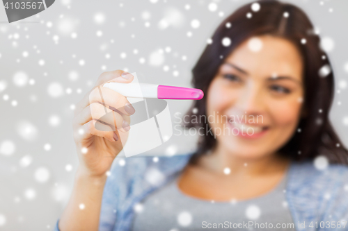 Image of close up of happy woman with home pregnancy test