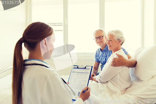 Image of senior woman and doctor with clipboard at hospital