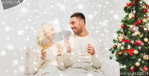 Image of happy couple at home with christmas tree