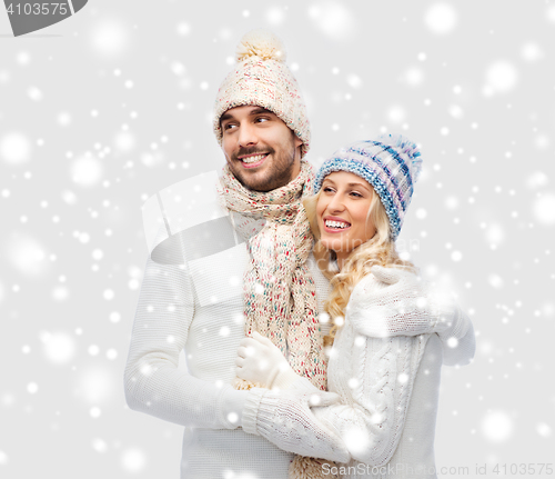 Image of smiling couple in winter clothes hugging