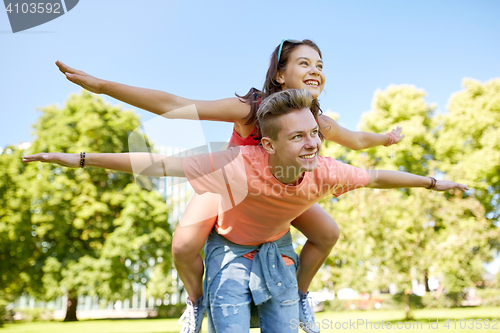 Image of happy teenage couple having fun at summer park