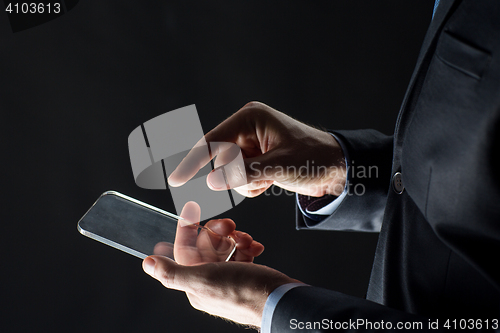 Image of close up of businessman with glass smartphone