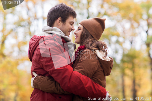 Image of happy young couple hugging in autumn park