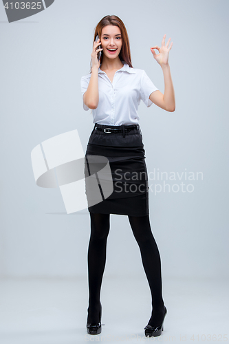 Image of The young business woman on gray background