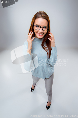 Image of The smiling young business woman on gray background