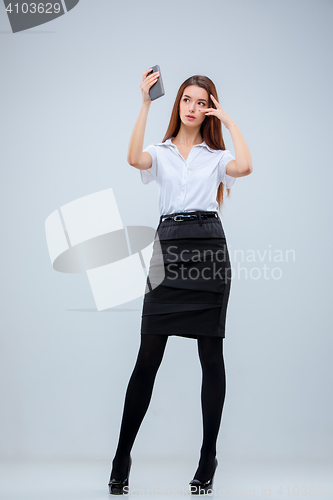 Image of The young business woman on gray background