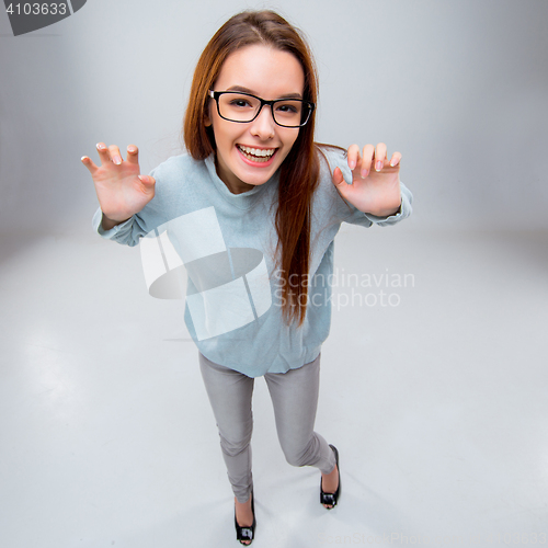 Image of The smiling young business woman on gray background