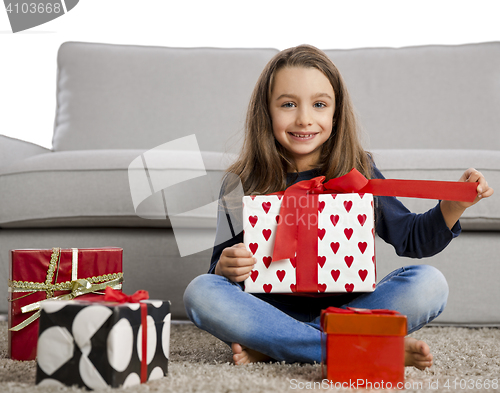 Image of Little girl opening presents