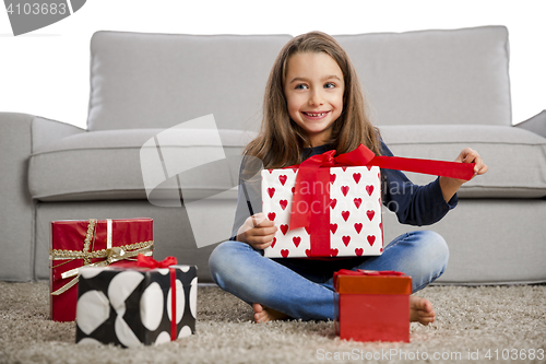 Image of Little girl opening presents