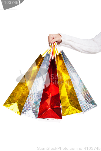 Image of Womans hand holding colorful shopping bags 