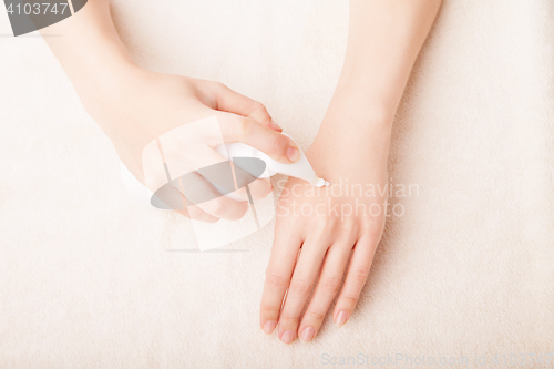 Image of Woman applying cream. Skin care concept