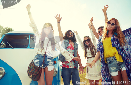 Image of smiling hippie friends having fun over minivan car