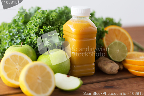 Image of bottle with orange juice, fruits and vegetables