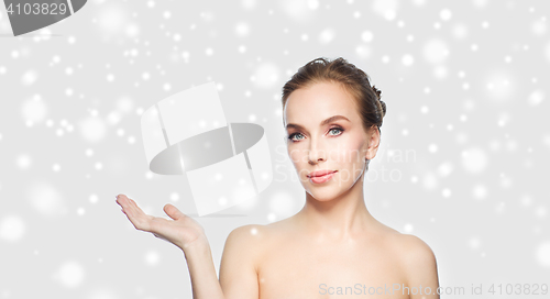 Image of smiling young woman face and shoulders over snow