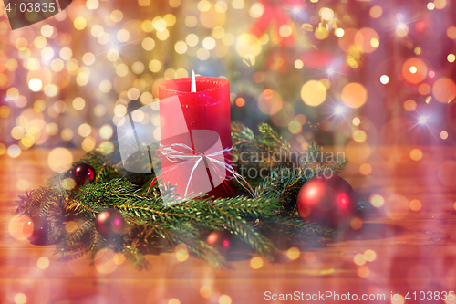 Image of christmas fir wreath with candle on wooden table