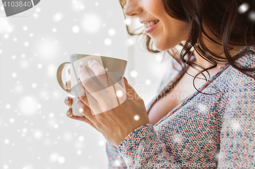 Image of close up of woman with tea or coffee cup at home