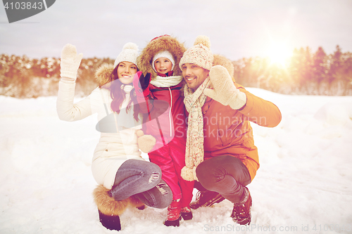 Image of happy family waving hands outdoors in winter