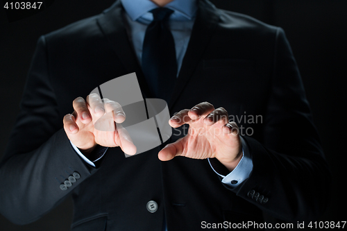 Image of close up of businessman touching virtual screen