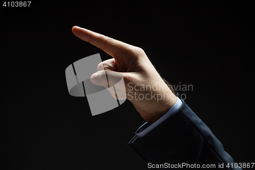 Image of close up of hand pointing finger to something