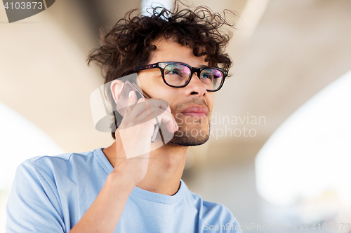 Image of man with smartphone calling on city street