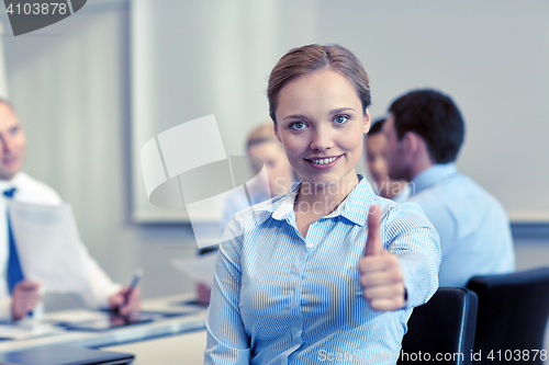 Image of group of smiling businesspeople meeting in office