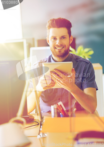 Image of happy creative male office worker with tablet pc