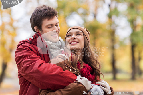 Image of happy young couple hugging in autumn park