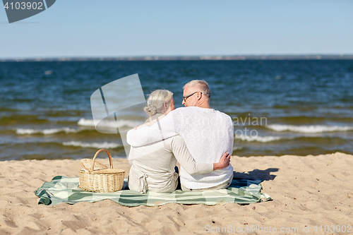 Image of happy senior couple hugging on summer beach