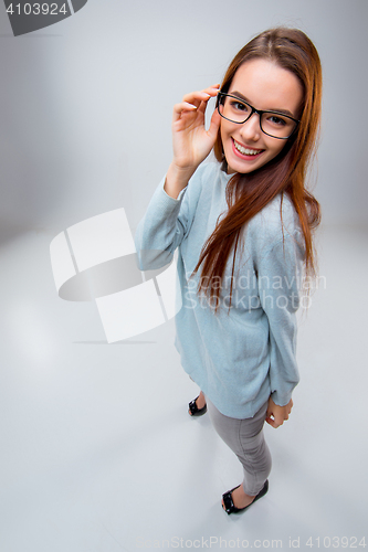 Image of The smiling young business woman on gray background