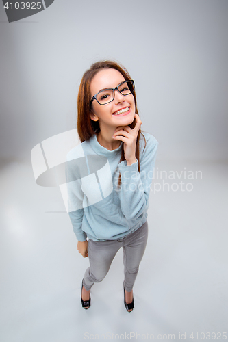 Image of The smiling young business woman on gray background