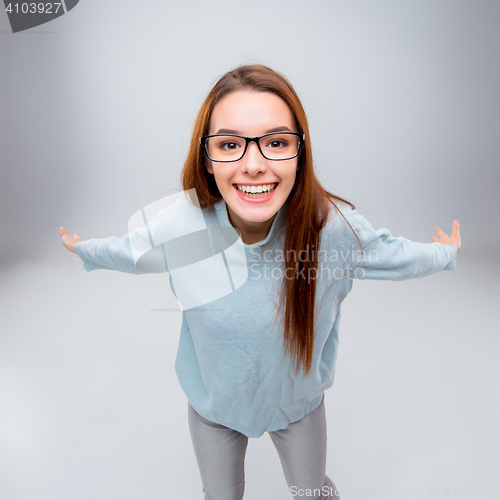 Image of The smiling young business woman on gray background