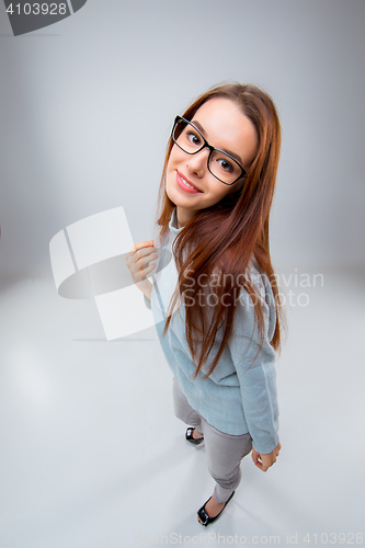 Image of The smiling young business woman on gray background