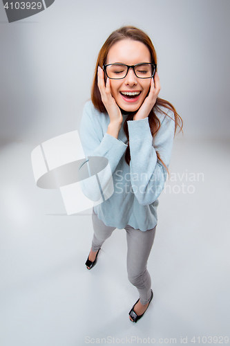 Image of The smiling young business woman on gray background