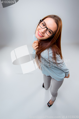 Image of The smiling young business woman on gray background