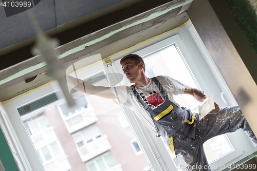 Image of Plasterer renovating indoor walls and ceilings. Finishing works.