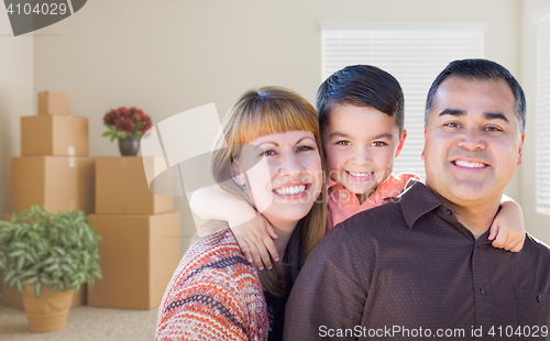 Image of Mixed Race Family with Baby in Room with Packed Moving Boxes