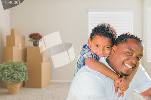 Image of Mixed Race African American Father and Son In Room with Packed M