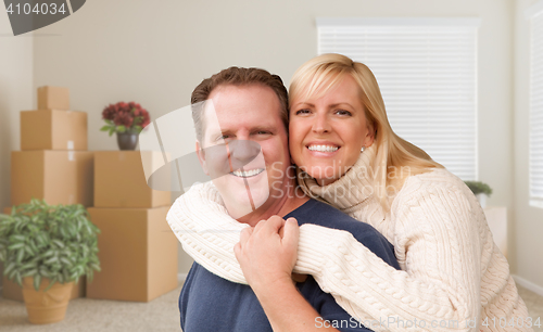 Image of Young Couple in Empty Room with Packed Boxes