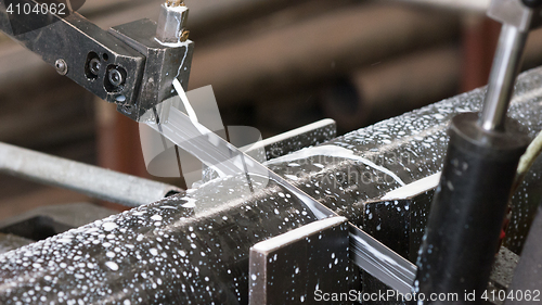 Image of Bandsaw cutting a steel pipe