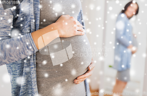 Image of close up of pregnant woman looking to mirror