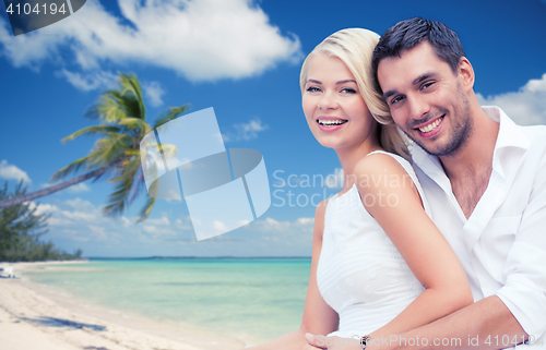 Image of couple having fun and hugging on beach