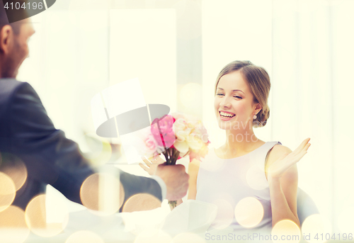 Image of amazed woman recieving bouquet of flowers