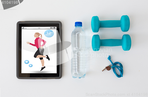 Image of tablet pc, dumbbells, whistle and water bottle
