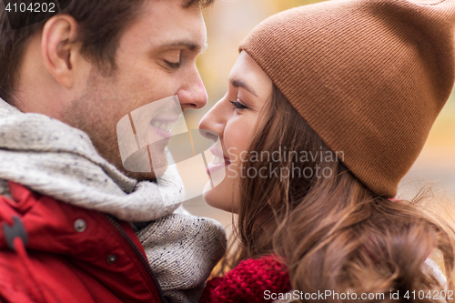 Image of close up of happy young couple kissing outdoors