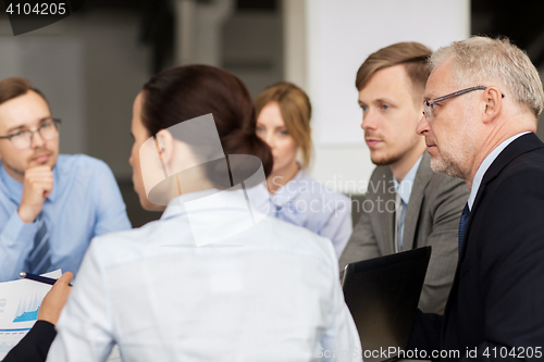 Image of smiling business people meeting in office