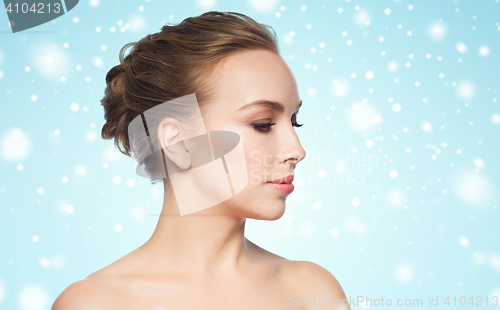 Image of beautiful young woman face over snow